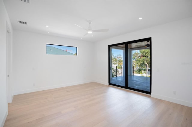 unfurnished room featuring light wood-style floors, recessed lighting, visible vents, and baseboards