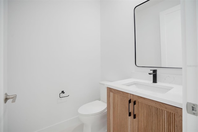 half bathroom featuring toilet and vanity