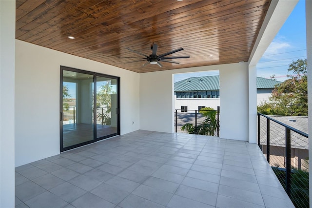 view of patio with a balcony and a ceiling fan