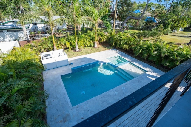 view of pool featuring a pool with connected hot tub and a patio area