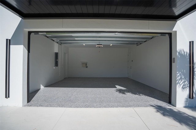 garage featuring a garage door opener and electric panel