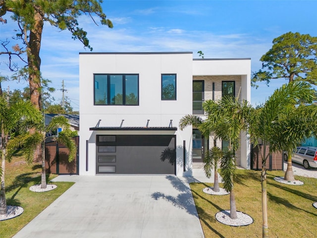 contemporary home featuring a garage and a front lawn