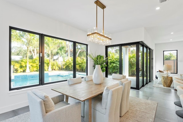 dining room with a chandelier, baseboards, and recessed lighting