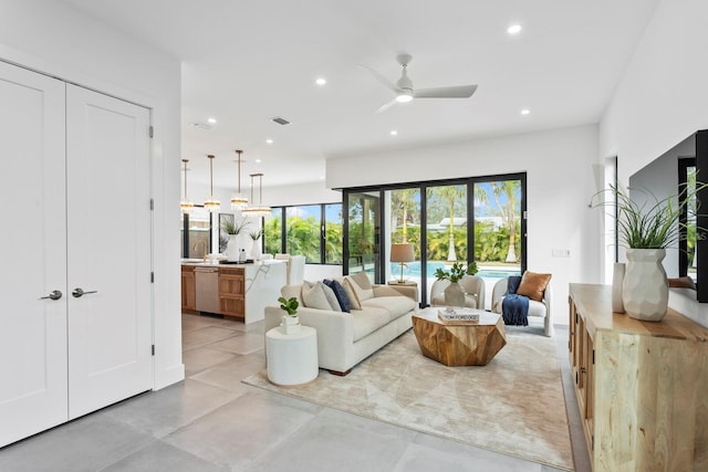 living room with a ceiling fan, recessed lighting, visible vents, and concrete floors