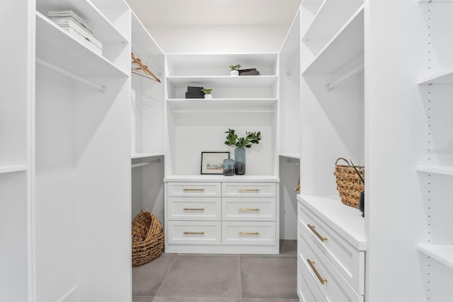 spacious closet with light tile patterned floors