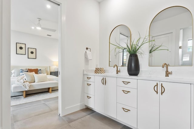 full bathroom featuring a ceiling fan, a sink, ensuite bath, and double vanity