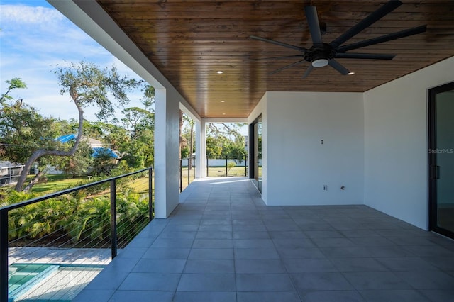 view of patio with a balcony and ceiling fan