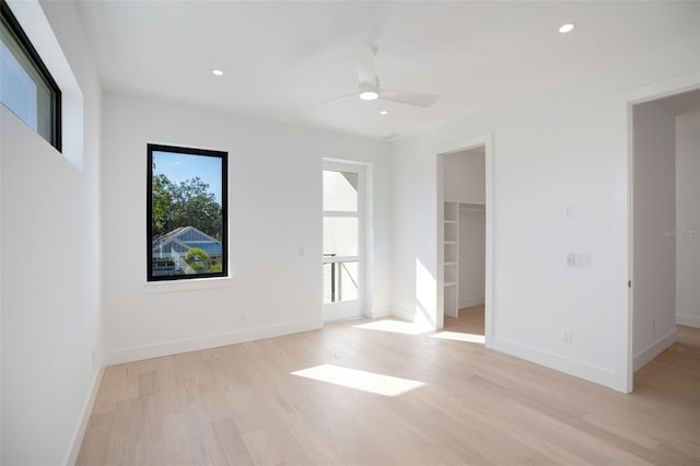 empty room featuring light wood-style floors, baseboards, and recessed lighting