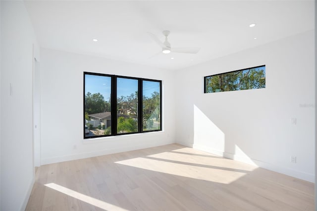 unfurnished room featuring baseboards, a ceiling fan, light wood-style flooring, and recessed lighting