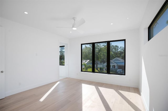 unfurnished room with light wood-type flooring, ceiling fan, baseboards, and recessed lighting