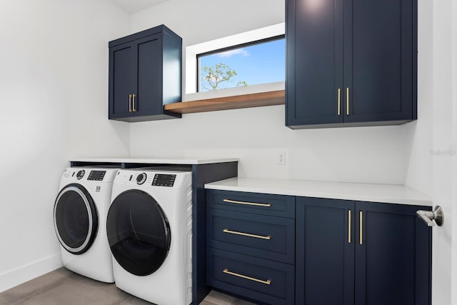 laundry area with washer and clothes dryer, cabinet space, and baseboards