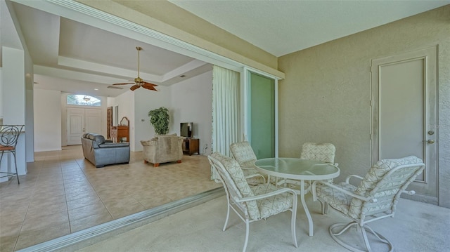 interior space with a tray ceiling and ceiling fan