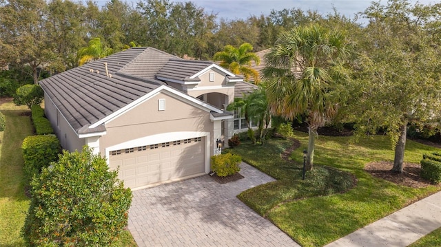 view of front of property with a garage and a front lawn