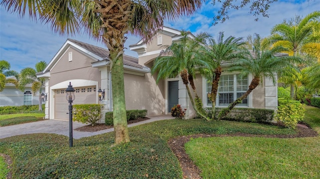 view of front of property with a front yard and a garage