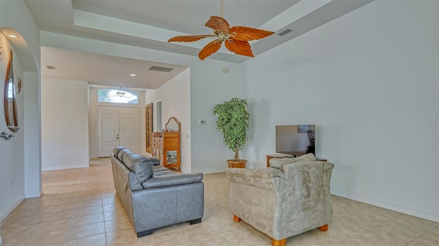 tiled living room featuring ceiling fan