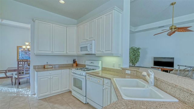 kitchen with white cabinets, light tile patterned flooring, white appliances, and sink