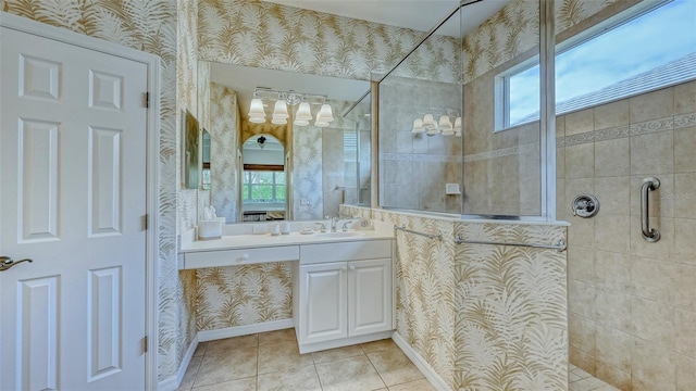 bathroom with vanity, a healthy amount of sunlight, and a tile shower