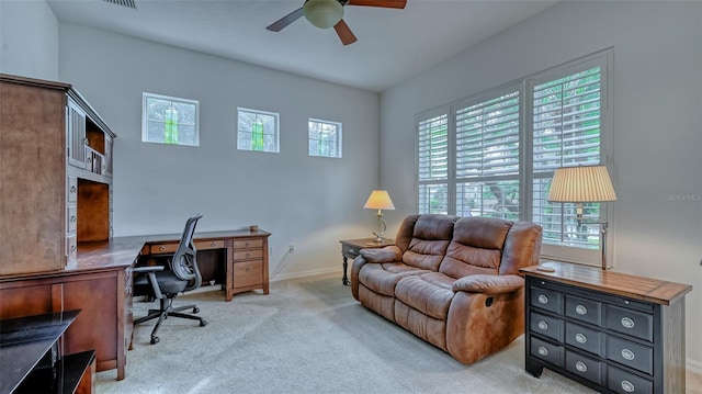 carpeted home office featuring ceiling fan