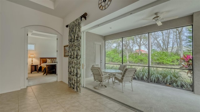 unfurnished sunroom featuring ceiling fan