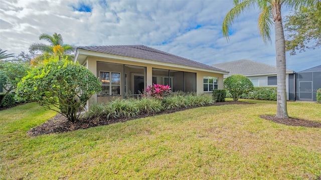 back of property featuring a lawn