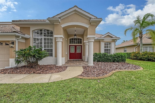 view of front of house with a front lawn and a garage