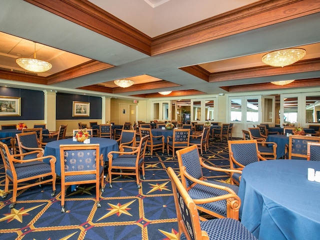 dining room featuring crown molding, an inviting chandelier, coffered ceiling, and a tray ceiling