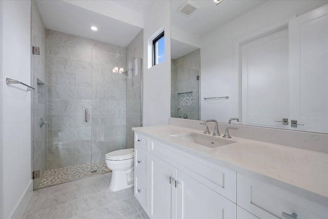 bathroom with a shower with shower door, vanity, and toilet