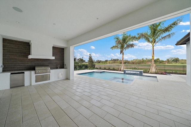 view of swimming pool with area for grilling, an in ground hot tub, an outdoor kitchen, a patio, and pool water feature