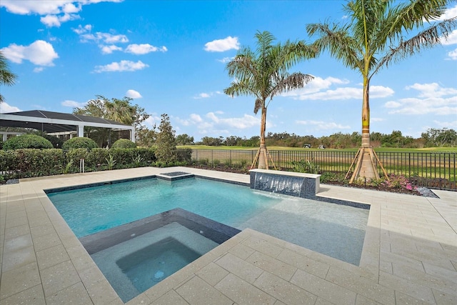 view of swimming pool with pool water feature, a patio, and an in ground hot tub