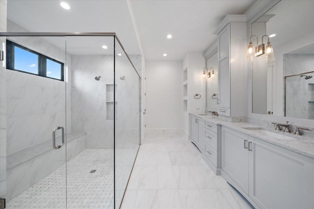 bathroom with a shower with door and vanity