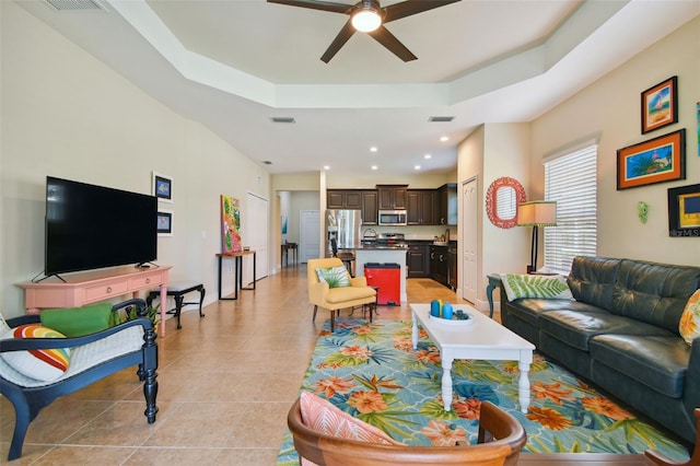 4618 Deep Creek Ter, Parrish, FL 34219 - living room featuring light tile floors, ceiling fan, a raised ceiling, and sink