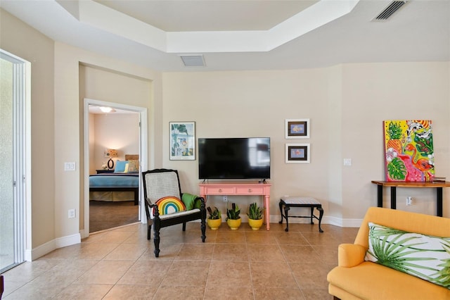 4618 Deep Creek Ter, Parrish, FL 34219 - living room featuring light tile flooring and a tray ceiling