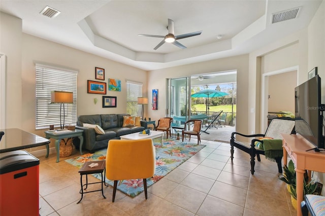 4618 Deep Creek Ter, Parrish, FL 34219 - living room featuring light tile floors, a raised ceiling, and ceiling fan