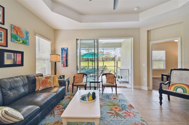 4618 Deep Creek Ter, Parrish, FL 34219 - living room featuring a raised ceiling, ceiling fan, light tile floors, and a wealth of natural light
