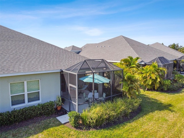 4618 Deep Creek Ter, Parrish, FL 34219 - rear view of house with glass enclosure and a lawn