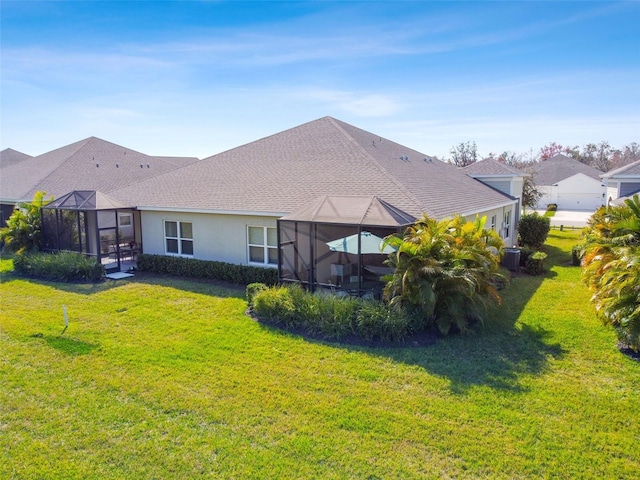 4618 Deep Creek Ter, Parrish, FL 34219 - back of house featuring a lawn and glass enclosure