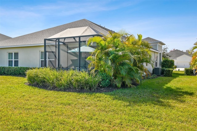 4618 Deep Creek Ter, Parrish, FL 34219 - view of home's exterior with a yard, central air condition unit, and glass enclosure