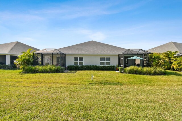 4618 Deep Creek Ter, Parrish, FL 34219 - back of property featuring a yard and glass enclosure