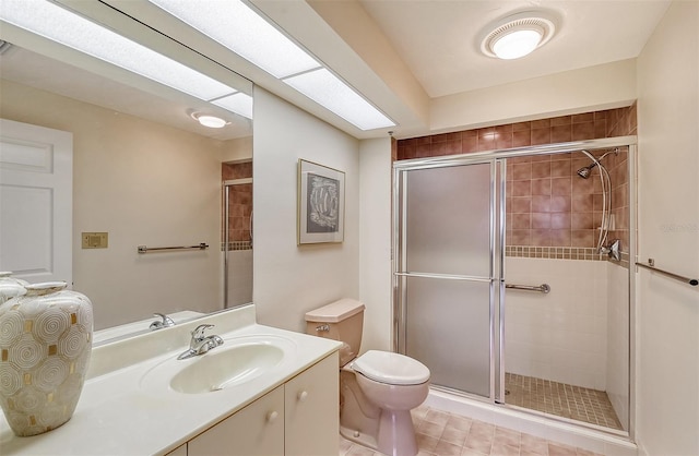 bathroom featuring vanity, tile flooring, a shower with shower door, and toilet