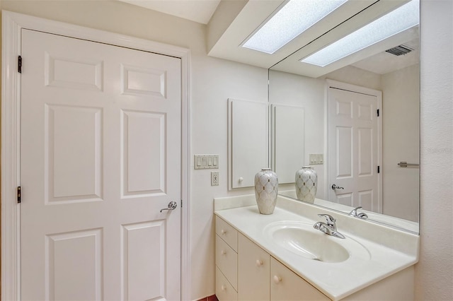 bathroom with vanity and a skylight