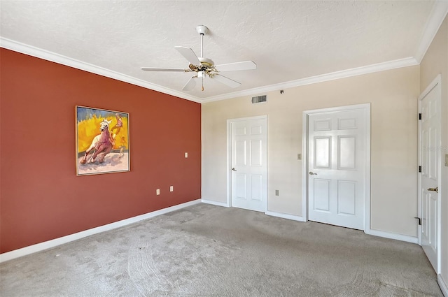 unfurnished bedroom featuring light colored carpet, a textured ceiling, ceiling fan, and ornamental molding