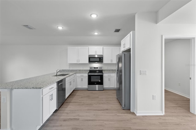 kitchen with light stone countertops, stainless steel appliances, light wood-type flooring, and white cabinetry