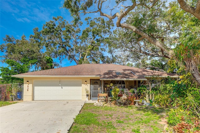 ranch-style home featuring a garage and a front yard