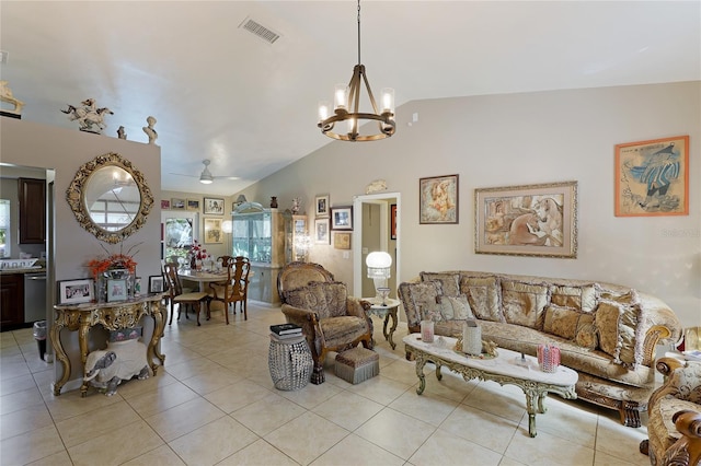 living room with ceiling fan with notable chandelier, lofted ceiling, and light tile patterned floors