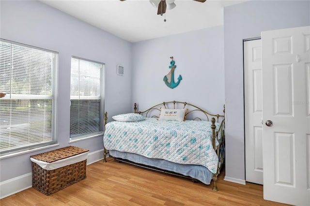 bedroom with a closet, ceiling fan, and light wood-type flooring