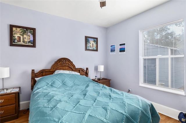 bedroom featuring ceiling fan and light hardwood / wood-style flooring