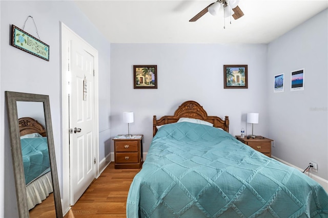 bedroom with ceiling fan and hardwood / wood-style flooring