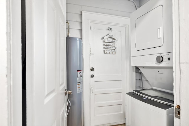 laundry room with electric water heater and stacked washing maching and dryer