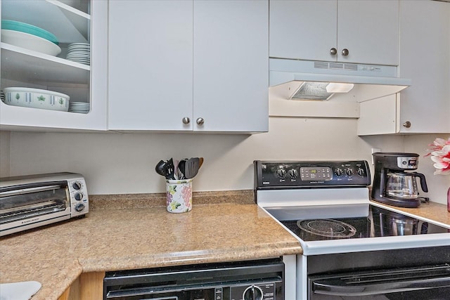 kitchen with electric stove, white cabinetry, and custom exhaust hood