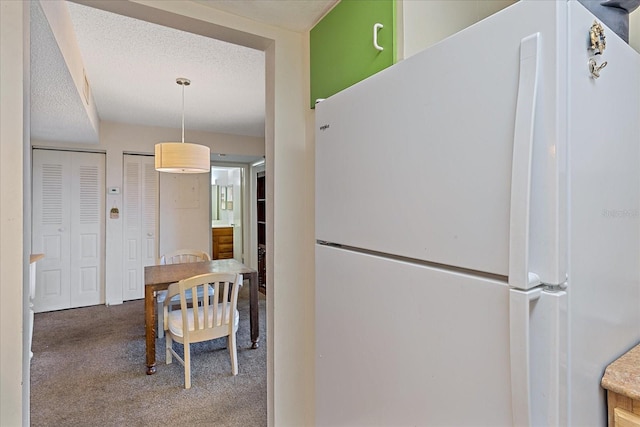 dining area with light carpet and a textured ceiling